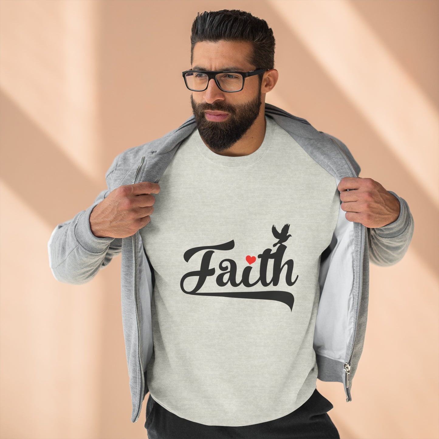 Light brown skinned man with glasses and straight hair with his hooded sweatshirt open is wearing a second sweatshirt that says "FAITH"